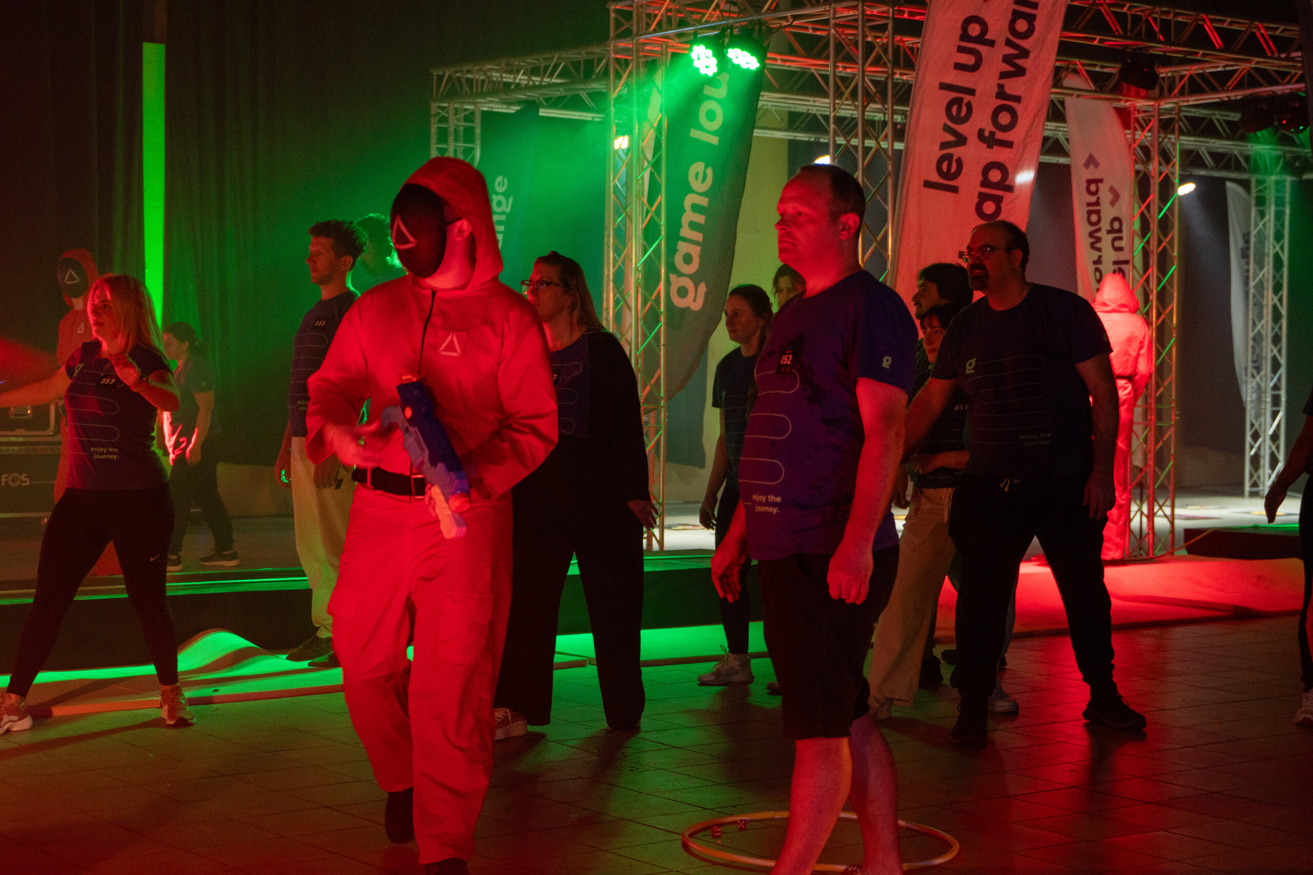 Squid Game style team building activity in Malta with corporate teams participating in competitive challenges at an indoor event.